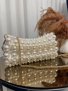 Pearl Bead Bag | Pearl Clutch Bag | Pearl Handbag  ✨ Elevate your style with this handmade white pearl bead bag, combining elegance and sophistication. 🌟 Perfect for weddings, parties, and special events, this bag is a must-have accessory that adds a touch of glamour to any outfit. 💍 - Crafted with high-quality pearl beads for a luxurious look ✨ - Durable and stylish, designed to last 💎 - Ideal for special occasions and formal events 🎉 - Dimensions: [10 cm x 22 cm - (3,93 inch x 8,66 inch) Chic Pearl Embellished Shoulder Bag, Pearl White Beaded Shoulder Bag For Party, Beaded Shoulder Bag Clutch, Chic Clutch With Pearl Embroidery, Handheld Clutch With Pearl Handle, Chic Beaded Handheld Clutch, Beaded Beige Bags For Party, White Clutch With Pearl Handle, Beige Beaded Bags For Party