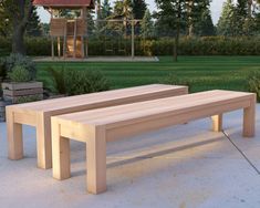 a wooden bench sitting on top of a cement ground