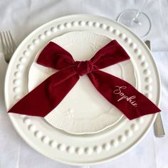 a white plate topped with a red bow