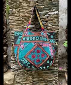 About bag  Indo-gypsy fusion, everyday use hand bag made from Banjara fabrics sourced from Vintage tribal costumes of regions of Rajastan and Gujarat. These are embellished with light catching coins, and intricate bead work tassels. Size - length 15 inches/ width 21 inches Company details:  Company name: Houseoftextile  Contact number: +919784447473  Email id: houseoftextile77@gmail.com  Shipping & custom : Delivery through one of the finest service providers : Skyway, Fedex, UPS  And DHL. Any l Bohemian Multicolor Double Handle Beach Bag, Bohemian Black Shoulder Bag For Festivals, Black Bohemian Shoulder Bag For Festivals, Bohemian Tote Bag For Market, Multicolor Bags With Woven Motifs For Market, Festival Patchwork Tote Bag, Multicolor Handwoven Shoulder Bag For Festivals, Handmade Festival Hobo Tote Bag, Bohemian Green Bag With Double Handle