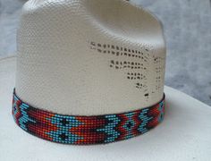 This beautiful beaded hat band is **OUTRAGEOUSLY DISTINCTIVE** in both color and design. This is a wider stunningly beautiful beaded hat band and STRETCHES to fit your hat band. Amazing beaded hat band from Knot-a-Tail This one is an 11 row design and it is just a touch over 7/8 inch wide. ** EXTRA wide so it gets ** NOTICED Totally adjustable from a about 20 inches to a LARGE 30 inches to easily fit most hat sizes. Take a look at this STUNNING Native American designed Beaded hat band. Just to m Adjustable Beaded Hat Bands, Adjustable Hat Band With Bead Caps For Festival, Adjustable Bead Cap Hat Bands For Festival, Adjustable Beaded Fedora Hat Band, Custom Adjustable Summer Hat Bands, Multicolor Beaded Hat Band For Rodeo, White Beaded Hat Bands For Rodeo, White Beaded Hat Band For Rodeo, Multicolor Beaded Hats For Rodeo