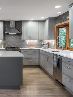 a modern kitchen with stainless steel appliances and wood flooring