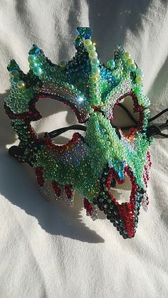 Dragon like, custom designed, hand gemmed mask. Handmade Fantasy Eye Mask, Rhinestone Masquerade Mask For Mardi Gras Carnival, Mardi Gras Masquerade Mask With Rhinestones For Carnival, Carnival Rhinestone Eye Mask, Handmade Fantasy Masks For Masquerade, Rhinestone Mask For Carnival Masquerade, Handmade Fantasy Costume Masks, Handmade Fantasy Masquerade Mask For Costume Party, Rhinestone Mask For Masquerade Carnival