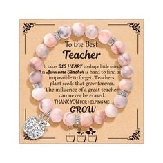 a pink bracelet with the words to the best teacher on it and a heart charm