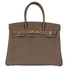 100% authentic Hermès Birkin 30 bag in Etoupe (taupe) Veau Togo leather with gold-plated hardware and contrasting white stitching. Lined in Chèvre (goat skin) with an open pocket against the front and a zipper pocket against the back. Has been carried and is in virtually new condition. Comes with Full Set. Measurements Model H027633CC 18 Height 22cm (8.6in) Width 30cm (11.7in) Depth 15cm (5.9in) Drop of the Handle 10.5cm (4.1in) Hardware Gold-Plated Blindstamp Z (2021) All our listings include o Classic Togo Leather Bag With Gold-tone Hardware, Formal Togo Leather Bag With Gold-tone Hardware, Timeless Togo Leather Bag With Gold-tone Hardware, Elegant Togo Leather Bag With Gold-tone Hardware, Rectangular Togo Leather Bag With Gold-tone Hardware, Business Bags In Taupe With Palladium Hardware, Taupe Business Bags With Palladium Hardware, Luxury Togo Leather Office Bag, Elegant Togo Leather Bags For Everyday Use