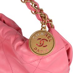 This Small 22 hobo bag is of pink calfskin with gold tone hardware and has the signature diamond quilting, CHANEL on the front in gold metal, removable pouch, and long gold tone and pink leather chain.The interior is lined in pink fabric with one zip pocket on the rear wall.Collection: 22AOrigin: ItalyCondition: New and never wornAccompanied by: Chanel box, Chanel dustbag and retail UPCMeasurements: 12" width x 11" height x 3.25" depth; 8" strap drop Everyday Pink Shoulder Bag With Metal Logo, Pink Shoulder Bag With Metal Logo For Everyday, Gold Quilted Top Handle Bag, Designer Pink Bag With Metal Logo, Luxury Pink Bag With Metal Logo, Luxury Pink Bags With Metal Logo, Gold Quilted Bag For Everyday Luxury, Pink Quilted Leather Bag, Luxury Shopping Bags With Metal Logo