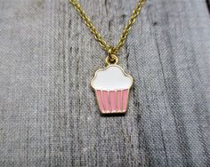 Cute cupcake necklace, with matching brass chain and closes with a lobster claw clasp. Pendant is 16mm long, 11mm wide Choose your length of chain during checkout. I package each piece of jewelry in a colorful organza bag. Perfect for gift giving or a gift for yourself. Don't forget to look through the add on section to add more customized fun. https://www.etsy.com/shop/RevelryJewelry Thank you fairy much. Sweet Nickel-free Jewelry Gift, Cute Charm Necklaces For Gifts, Sweet Nickel-free Jewelry For Gifts, Small Charm Necklace With Lobster Clasp For Gift, Handmade Gold Sweet Jewelry, Sweet Silver Necklace Perfect For Gifts, Sweet Gold Necklace For Gift, Sweet Gold Necklace As Gift, Sweet Gold Necklace Perfect For Gift