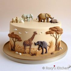 a cake decorated with elephants, giraffes and zebras