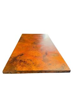 an orange table top with rusted metal on the edges and one end missing, against a white background