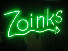 a green neon sign that says zink's