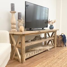 a flat screen tv sitting on top of a wooden stand