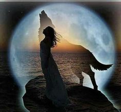 a woman standing next to a dog on top of a rock near the ocean under a full moon