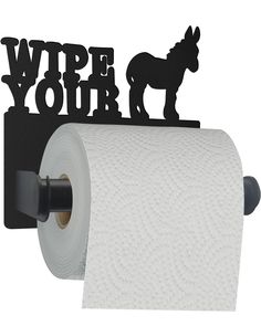 a roll of toilet paper sitting next to a black sign that says wipe your hands