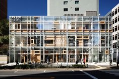 a large glass building sitting on the side of a road