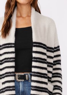 Why snuggle up with a blanket this Fall when you can have our cozy sweater instead? Our classic fuzzy cardigan, detailed with mirrored stripes, features an open front and handy patch pockets—ideal for your on-the-go lifestyle. Whether you’re at home, running errands or working from your favorite coffee shop, this plush cardigan ensures you step out in both comfort and style. Striped Relaxed fit Fuzzy texture Long sleeve Drop shoulder Open front Mid-length Shawl collar Patch pockets Bohemian stat Striped V-neck Cardigan For Work, Oversized Striped Long Sleeve Cardigan, Luxury Striped Winter Cardigan, Casual Striped V-neck Cardigan, Cozy Multicolor V-neck Cardigan, Fall Cardigans, Fuzzy Cardigan, Striped Cardigan, Shawl Collar