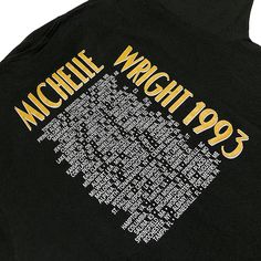 the back of a black michael wright jacket with yellow letters on it and white writing