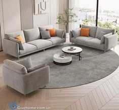 a living room filled with gray couches and chairs