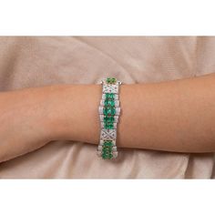 This is part of Chairish’s Fine Jewelry assortment.  This Art Deco Emerald Diamond Wedding Bracelet in 18K gold showcases 40 endlessly sparkling natural emerald, weighing 23.74 carat and diamonds weighing 7.09 carat. It measures 7.5 inches long in length.  Emerald enhances the intellectual capacity of the person. Designed with perfect oval cut emerald set horizontally in between the diamonds with diamond charm in center to make you stand out on any occasion or event. The elegant style complements the attire beautifully and this is a perfect Unique Gift, Bridal Shower Gift, Secret Santa Gift, Gift For Sister, Mother Daughter Gift, Bride To Be Gift, Bridesmaid Gift, Thanksgiving Gift, Anniversary Present, Christmas Gift or any Holiday Gift for Mother, Sister, Daughter, Grandma, Fiancé, Girlf Luxury Green Diamond Bracelet Hand Set, Green Diamond Bracelet For Formal Occasions, Green Diamond Bangle Bracelet For Formal Occasions, Formal Green Diamond Bangle Bracelet, Luxury Green Hand Set Diamond Bracelet, Emerald Tennis Bracelet With 17 Jewels For Wedding, Fine Jewelry Emerald Diamond Bracelet For Wedding, Emerald Diamond Bracelet For Wedding, Green Gemstone Diamond Bracelet For Formal Occasions