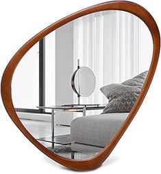 a mirror with a reflection of a couch in it