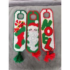 two christmas door hangers with santa clause on them