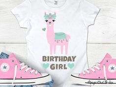 a pink and white shirt with an image of a llama wearing a birthday hat