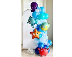 a bunch of balloons that are in the shape of sea animals