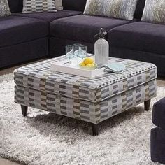 a living room filled with furniture and pillows on top of a white carpeted floor