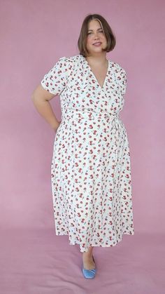 Base color is ivory with a unique strawberry print. Faux wrap bodice with v neckline. Short fitted sleeve. Ankle length skirt with a removable waist tie. Hidden back zipper. Lined throughout. Fabric has no stretch. Nursing friendly. Fabric is Shell - 100% Polyester, Lining - 97% Polyester, 3% Spandex. Machine wash cold; lay flat to dry. Available in sizes XXS, XS, S, M, L, XL, 1X, 2X, 3X, 4X, + 5X!! summer dress, summer outfit, summer style, wrap dress, tie dress, plus size fashion Style Wrap Dress, Ivy City Co, Dresses By Pattern, Strawberry Pattern, Ankle Length Skirt, Strawberry Fields, Nursing Friendly, Strawberry Print, Midi Short Sleeve Dress