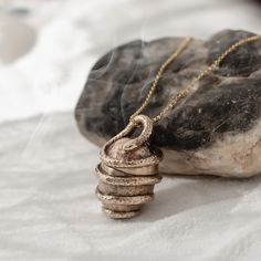 a necklace that is sitting on top of a rock