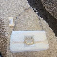 Brand New Never Used 9.84" W X 5.51" H X 2.36" D Drop Length Rhinestone Metal Chain - 9" Magnetic Snap Closure Interior - Inside Back Wall Slip Pocket, Back Wall Pocket Exterior - Silver-Tone Hardware Product Weight - 1.2 Lbs White Evening Shoulder Bag With Pearl Handle, White Shoulder Bag For Wedding, White Shoulder Evening Bag For Weddings, White Shoulder Evening Bag For Wedding, White Evening Satchel Shoulder Bag, White Shoulder Bag For Evening, White Evening Shoulder Bag, Embroidered Shoulder Bag, Fur Purse