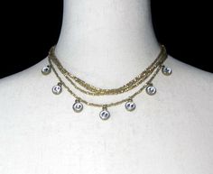 This item is a vintage gold tone and clear rhinestones 4-strand tiered necklace. This necklace is 15 to 19 inches, adjustable, with a lobster claw clasp. For daily, business and evening wear.  DETAILS:  ☼ Approximately 15 to 19 inches, adjustable. ☼ Approximately 40.8 grams, total weight. ☼ ☼ ☼ ☼ ☼ ☼ ☼ ☼ ☼ ☼ ☼ ☼ ☼ ☼ ☼ ☼ ☼ ☼ ☼ ☼ ☼ PLEASE NOTE:  ☼ Different items on SALE everyday!  Check back often to take advantage of these bargains! ☼ FREE DOMESTIC SHIPPING on purchases of $35 or more. Combined shipping is still available to domestic and international locations. ☼ This shop is happy to accept exchanges, returns for store credit.  Cash returns are only available in the rare event that an item is inaccurately described.  For example, if an item is described as gold but is actually silver or Tiered Necklace, Rhinestone Bead, Multi Strand Necklace, Necklace Vintage, Favorite Pins, Clear Rhinestones, Necklace Gift, Multi Strand, Lobster Claw