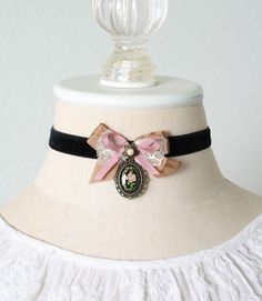 This Belle Epoque style choker necklace is handmade with a soft midnight black velvet ribbon. It features a fabulous bow made with soft silky ribbons and antique lace. A beautiful vintage floral cameo pendant hangs from the bow. A one-of-a-kind statement piece for girls and women who love to wear romantic and unique style jewelry. See last photos for coordinating designs. A fun group gift for mothers, daughters, sisters and friends! * Size ~ Adjustable length 12 - 15 inches with extender chain Bow Tie Ribbon, Cameo Choker, Collar For Women, Leg Garters, Black Velvet Ribbon, Hair Clasp, Ribbon Choker, Tie Ribbon, Nail Jewels