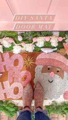 the feet of a person standing in front of a door mat with santa clause on it