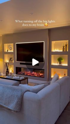 a living room filled with furniture and a flat screen tv mounted on the wall above a fire place