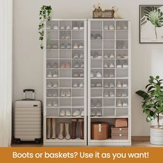 a white closet filled with lots of shoes next to a potted plant and suitcase