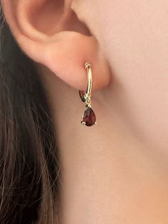 These hoop earrings make magic happen. A timeless design with a modern twist, the red garnet stone hoops will add sophistication to any outfit.  These earrings have been carefully handcrafted  14K yellow gold, and have one beautiful pear cut garnet that has been attached to the gorgeous hoops.  Choose white gold, yellow gold, or rose gold. Each piece is custom made   for you! These earrings come as a pair. ✦ Earrings Details: -      Total Earring Length Charm and Hoop- 0.78 Inc'' / 20 mm - Gold Earrings With Red Stone, Red Gemstones, Gold Birthday, Garnet Stone, Red Garnet, Jewelry Earrings Hoops, Gold Hoop, Pear Cut, Gold Hoop Earrings