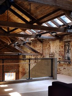 an industrial loft with exposed brick walls and beams