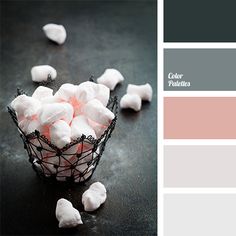 a bowl filled with marshmallows sitting on top of a black table next to a color swatch