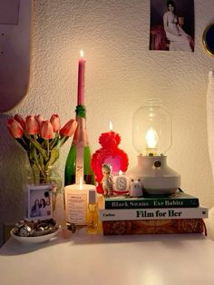 a white table topped with books and candles