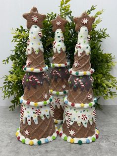 three christmas trees made out of ice cream and candy canes on top of each other