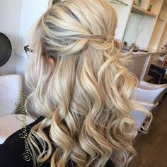 a woman with long blonde hair sitting in a salon