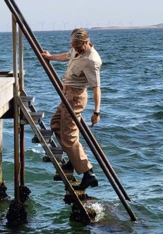 a man is walking up the stairs in the water