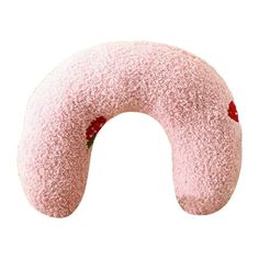 a pink donut shaped pillow sitting on top of a white surface