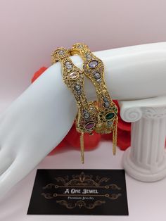 Indian bollywood fashion stunning 2pcs bridal wedding 22K gold plated kundan, polki bangles set size 2.6  These are high quality gold plated bangles set. Have done gold plating on it for a brilient shine. These looks great when you worn alone or in pair. They are sure to make your hands look beautiful. A popular combo to wear with many outfits. A perfect gift for your loved ones or yourself.  A perfect ornament for wedding, parties or any special event.  Stone Colour: Multi Main Colour: Gold Pro Elegant Gold Bangle With Latkans, Gold Tilla Bangle For Party, Traditional Gold Plated Bangle For Party, Gold Plated Bollywood Bracelet With Intricate Design, Gold Bracelets With Latkans For Wedding, Bollywood Style Gold Jeweled Jewelry Sets, Bollywood Style Gold Bridal Sets Hand Set, Bollywood Jeweled Wedding Bracelets, Bollywood Style Jeweled Wedding Bracelets