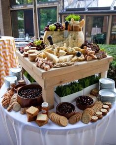 an image of a table with cheese and charcuterie bar on it, as well as other food items