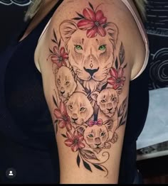 a woman's arm with an image of lions and flowers in the center on it