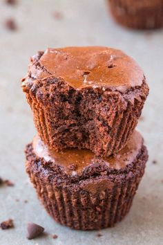 three chocolate cupcakes stacked on top of each other with one cut in half