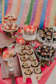 a table topped with lots of food and desserts