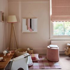 a child's room with pink walls and furniture