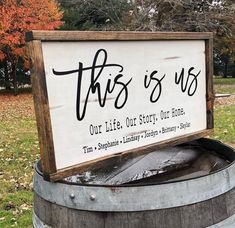 this is us sign sitting on top of a barrel